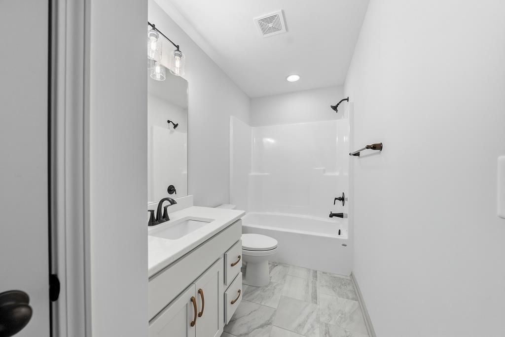 331 Lee Road 0357 Valley, AL 36854 - Photo 23 of 30 a bathroom with a sink a toilet and shower