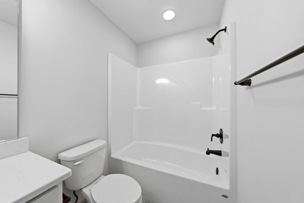 331 Lee Road 0357 Valley, AL 36854 - Photo 24 of 30 a bathroom with a toilet and a bathtub