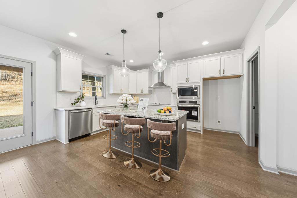 331 Lee Road 0357 Valley, AL 36854 - Photo 6 of 30 a kitchen with kitchen island a white counter top space a sink stainless steel appliances and cabinets