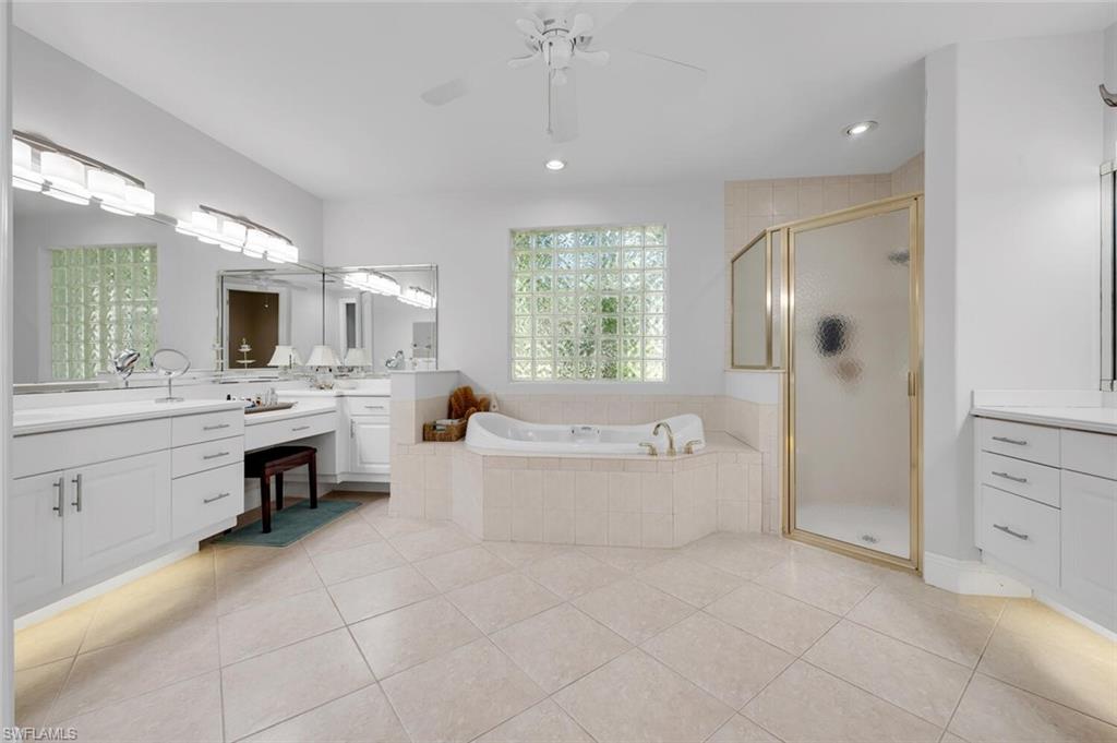 400 Terracina Way Naples, FL 34119 - Photo 12 of 29 Bathroom with separate shower and tub, tile patterned floors, and ceiling fan