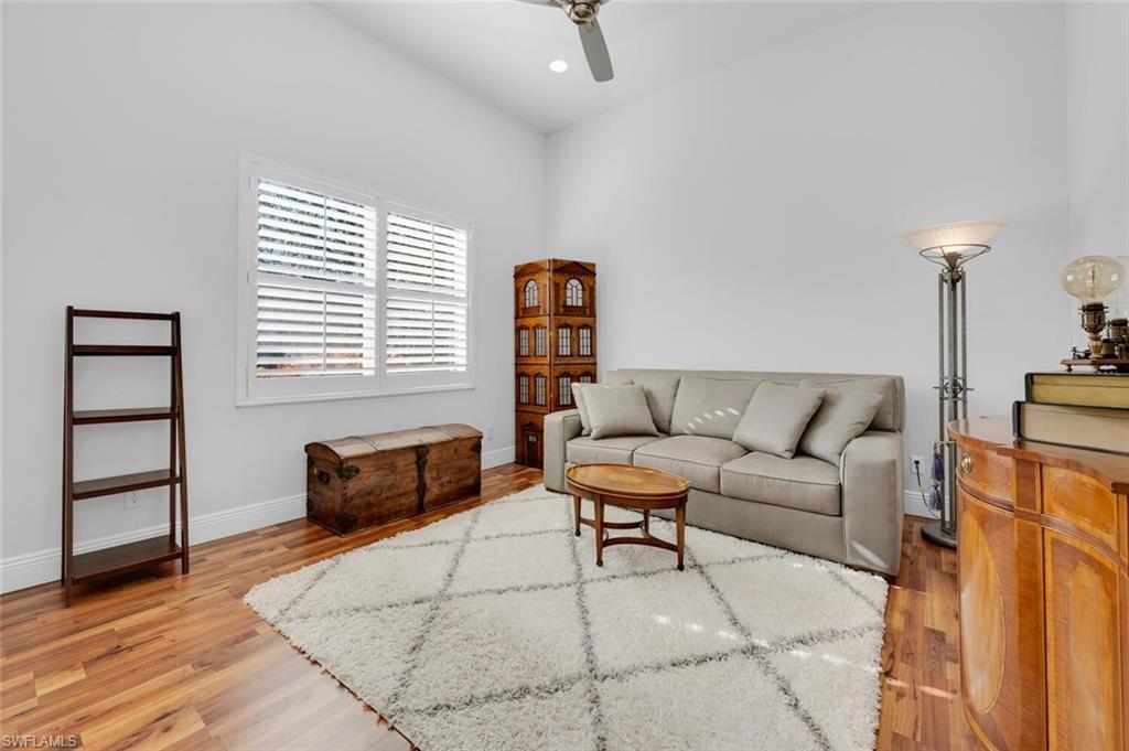 400 Terracina Way Naples, FL 34119 - Photo 14 of 29 Living room with ceiling fan and light wood-type flooring