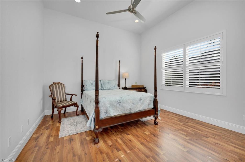 400 Terracina Way Naples, FL 34119 - Photo 16 of 29 Bedroom featuring ceiling fan and wood-type flooring