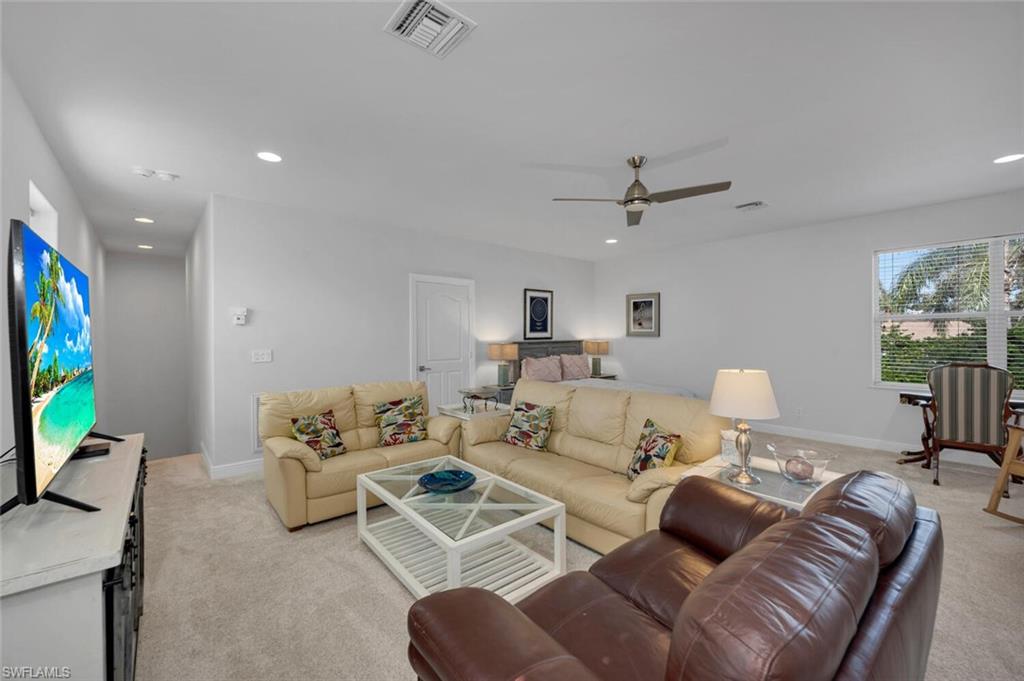 400 Terracina Way Naples, FL 34119 - Photo 18 of 29 Living room featuring light colored carpet and ceiling fan