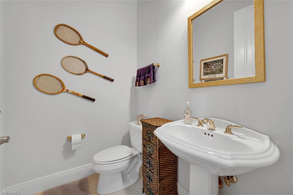 400 Terracina Way Naples, FL 34119 - Photo 20 of 29 Bathroom featuring tile patterned floors, toilet, and sink