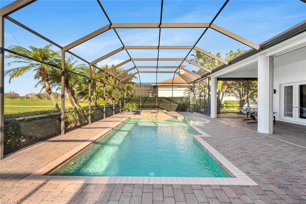 400 Terracina Way Naples, FL 34119 - Photo 24 of 29 View of pool with glass enclosure and a patio