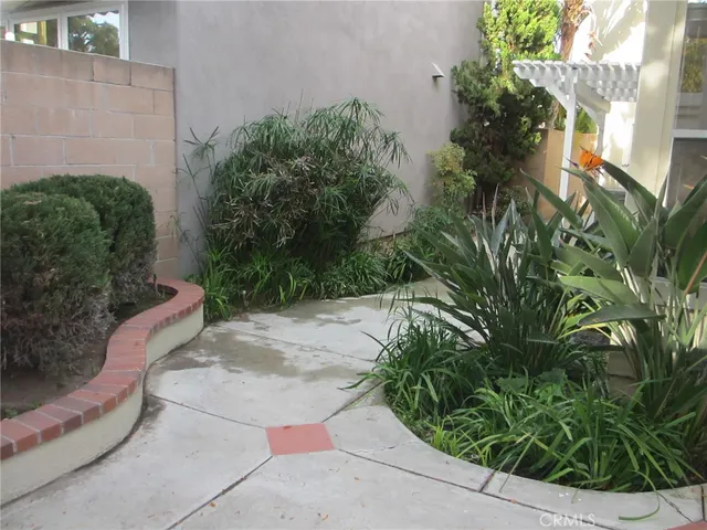 a view of a patio with table and chairs with wooden floor and fence