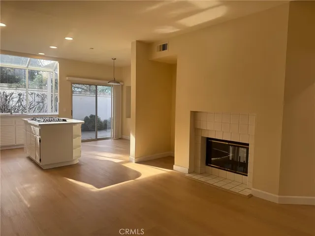 a view of a livingroom with a fireplace and window