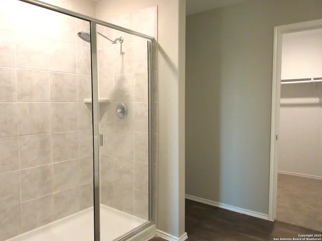 a bathroom with a glass shower door