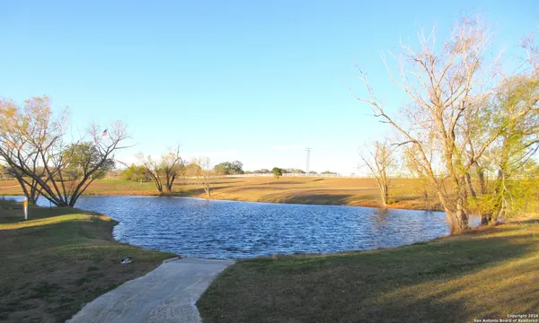 a view of a lake with a yard
