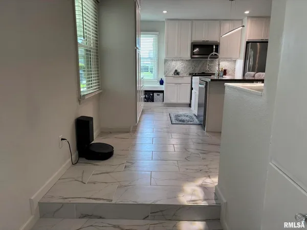 a kitchen with stainless steel appliances kitchen island granite countertop a sink and a stove