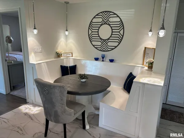 a kitchen with a table and chairs