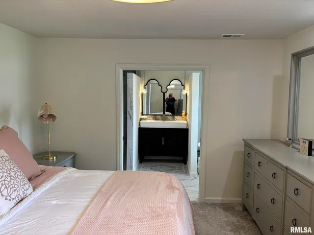 a bedroom with a bed and a dresser