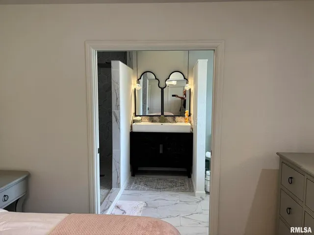 a bedroom with a bed and a dresser