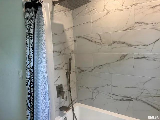 a bathroom with a bathtub and shower