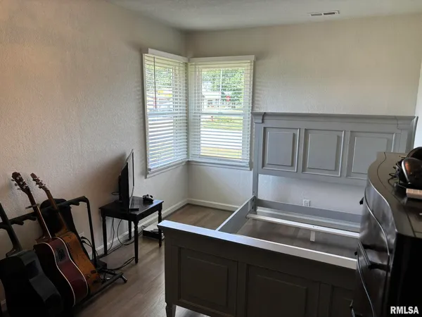 a bedroom with two beds and a chandelier