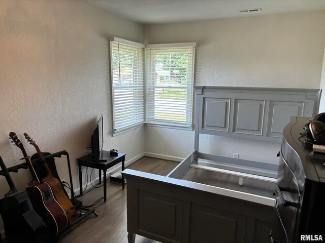 a bedroom with two beds and a chandelier