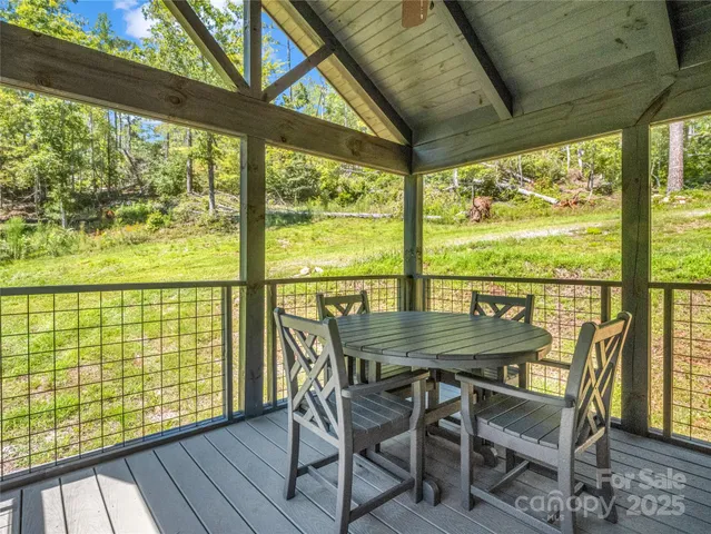 a view of a porch with furniture and wooden floor
