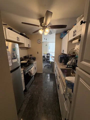 a kitchen with a sink appliances and cabinets