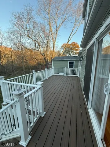a view of balcony with wooden floor and fence