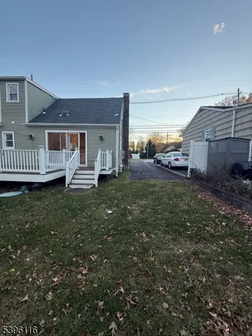 a front view of a house with a garden and deck