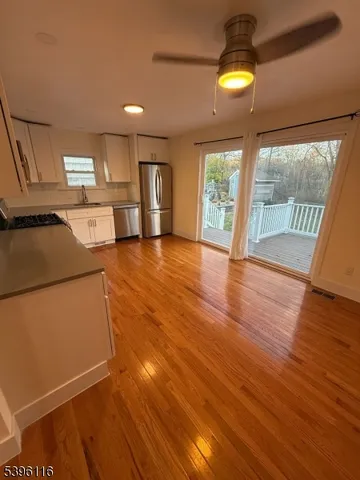 a view of a livingroom with furniture wooden floor and window