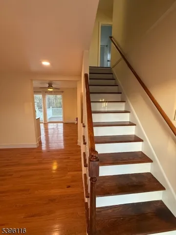 a view of entryway and hall with wooden floor