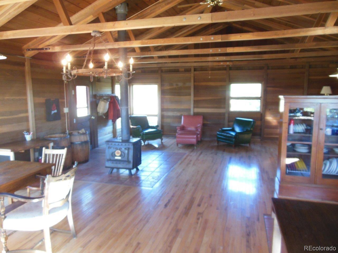 481 San Miguel Road Westcliffe, CO 81252 - Photo 12 of 26 a view of a living room with furniture and wooden floor