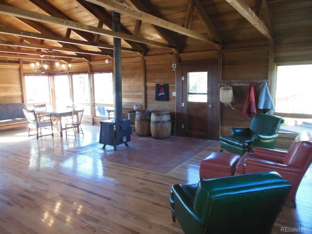 481 San Miguel Road Westcliffe, CO 81252 - Photo 13 of 26 a living room with furniture and a wooden floor