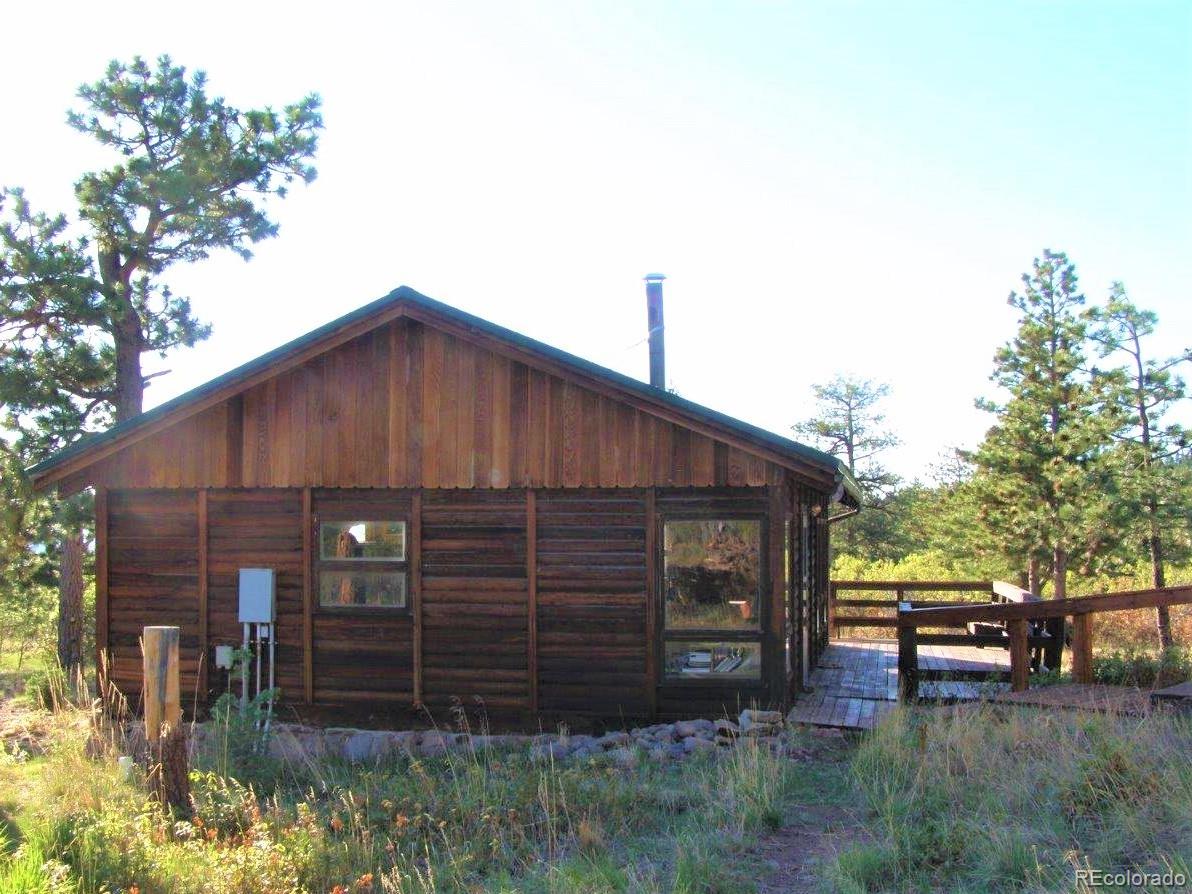 481 San Miguel Road Westcliffe, CO 81252 - Photo 17 of 26 a view of a house with a yard and wooden fence