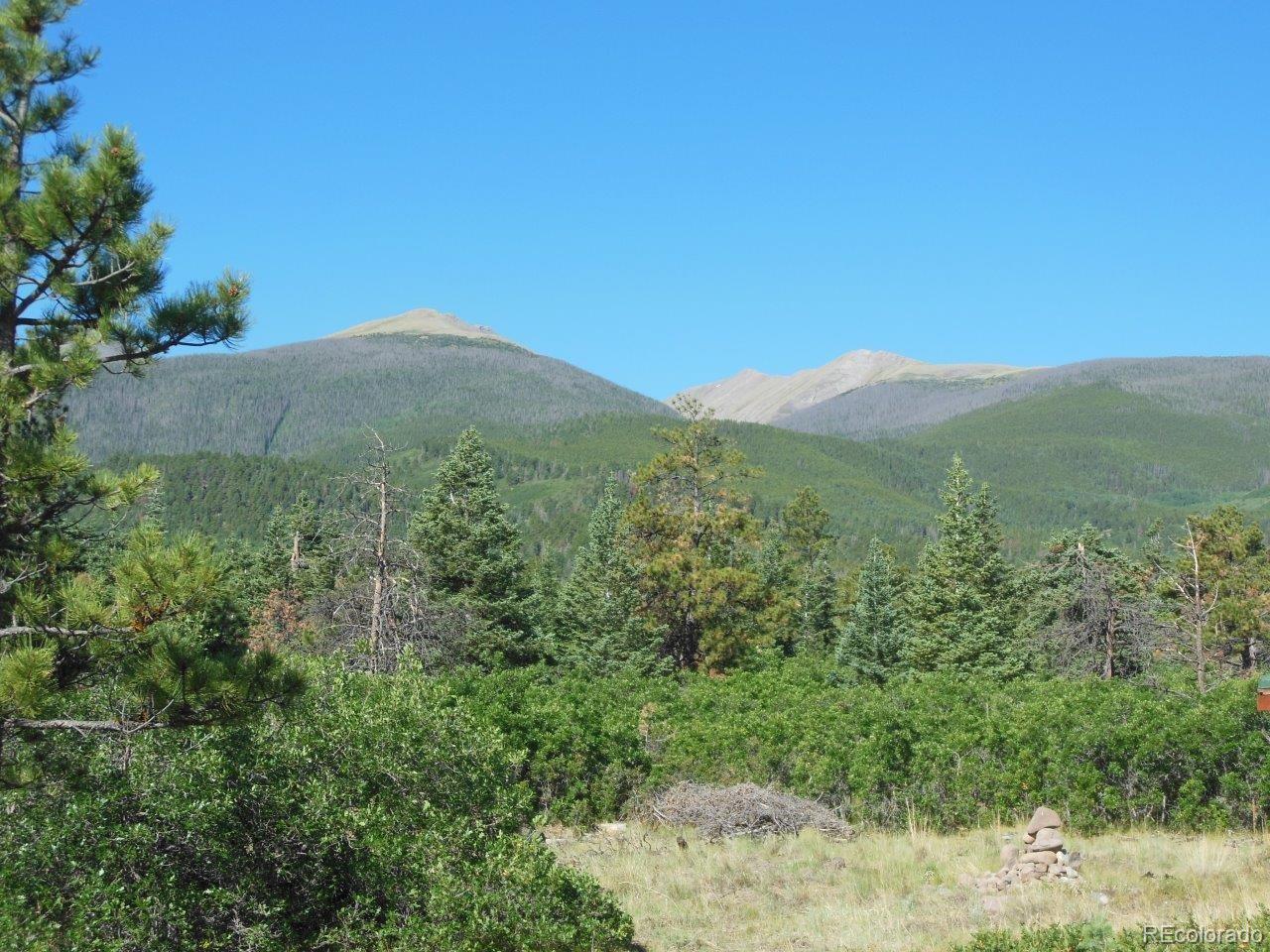 481 San Miguel Road Westcliffe, CO 81252 - Photo 23 of 26 a view of a lush green mountain in the middle of a field