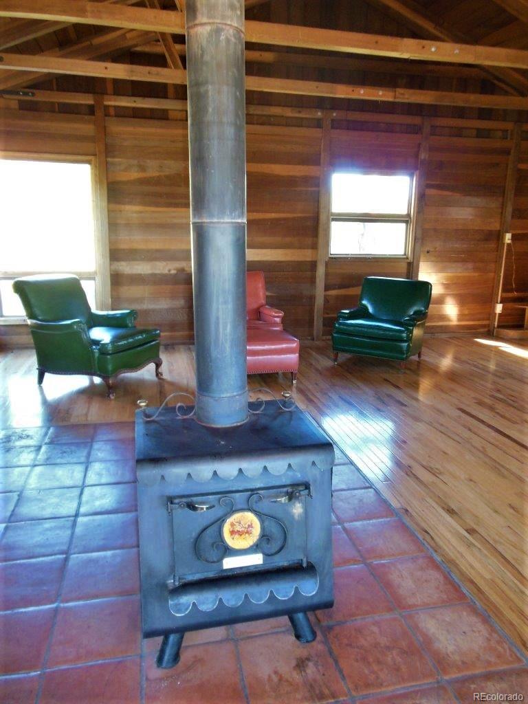 481 San Miguel Road Westcliffe, CO 81252 - Photo 5 of 26 a living room with furniture and a fireplace