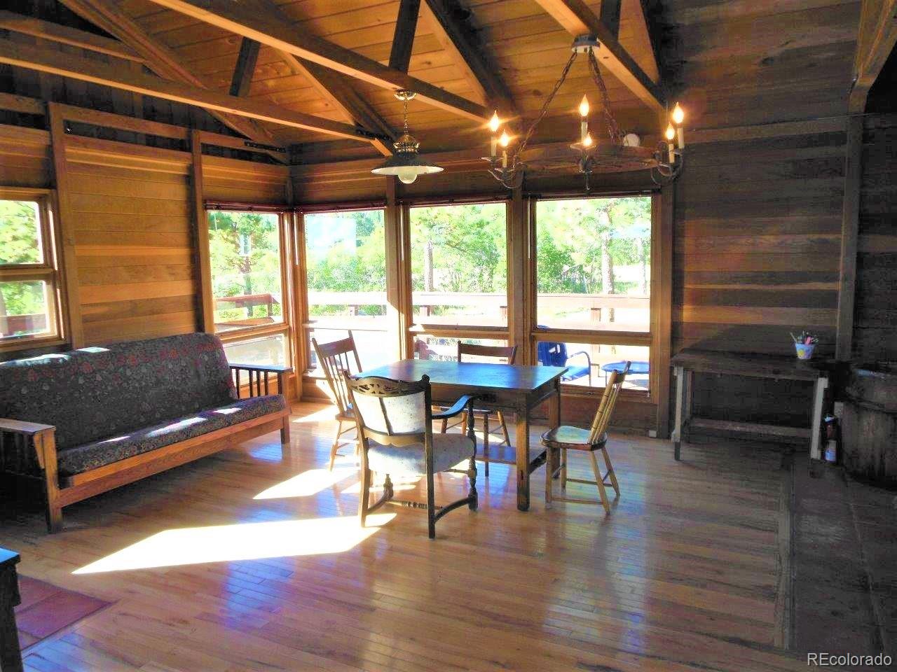 481 San Miguel Road Westcliffe, CO 81252 - Photo 6 of 26 a view of a dining room with furniture window and wooden floor