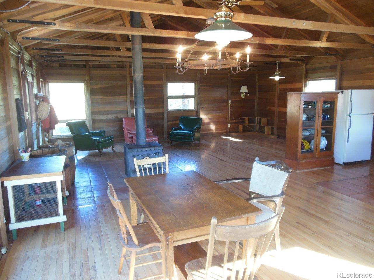 481 San Miguel Road Westcliffe, CO 81252 - Photo 8 of 26 a living room with fireplace furniture and a chandelier