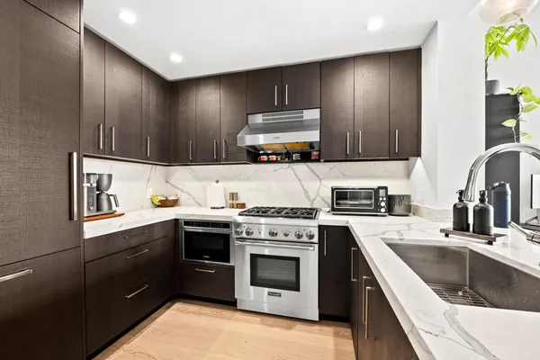 a kitchen with a stove top oven sink and cabinets