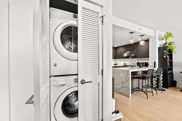 a view of a hallway with washer and dryer