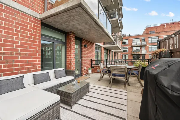 a view of a patio with couches table and chairs and potted plants