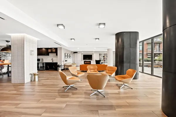 a living room with patio fireplace and dining table