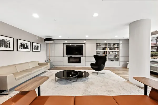 a living room with furniture a flat screen tv and a fireplace