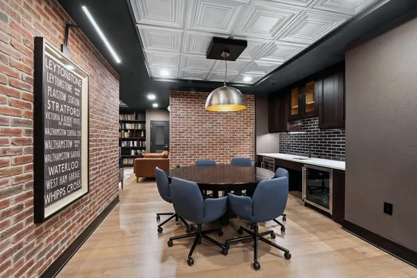 a dining room with furniture and wooden floor