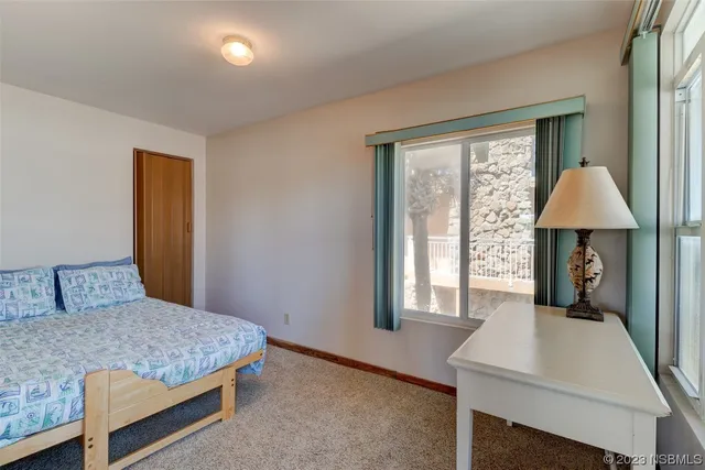 a bedroom with a bed and a table