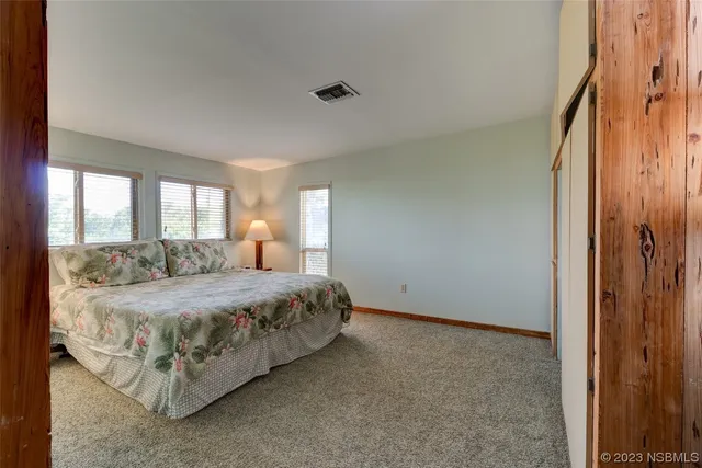 a spacious bedroom with a bed and window