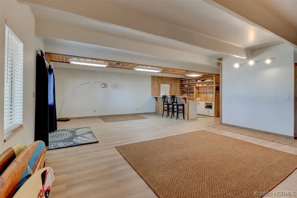 a view of a room with furniture and wooden floor