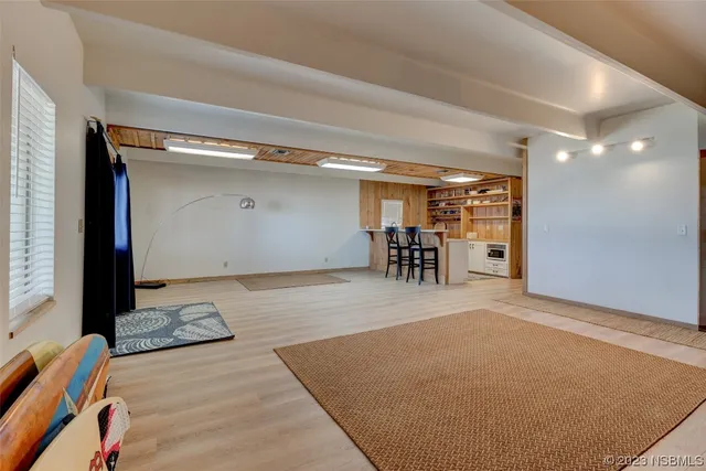 a view of a room with furniture and wooden floor