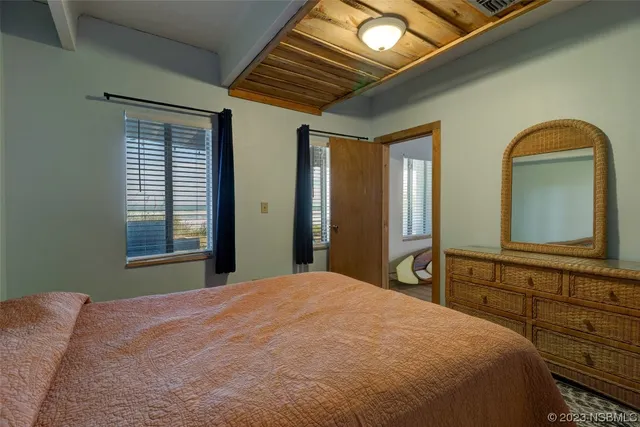 a view of a bathroom from a hallway with wooden floor