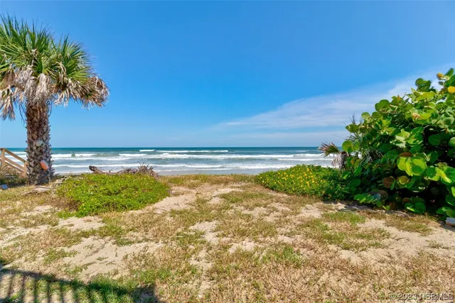 a view of a patio with furniture and garden