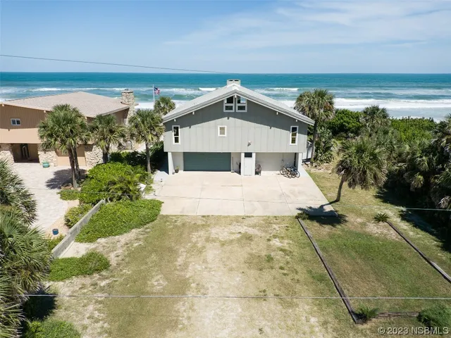 a view of a white house with a yard