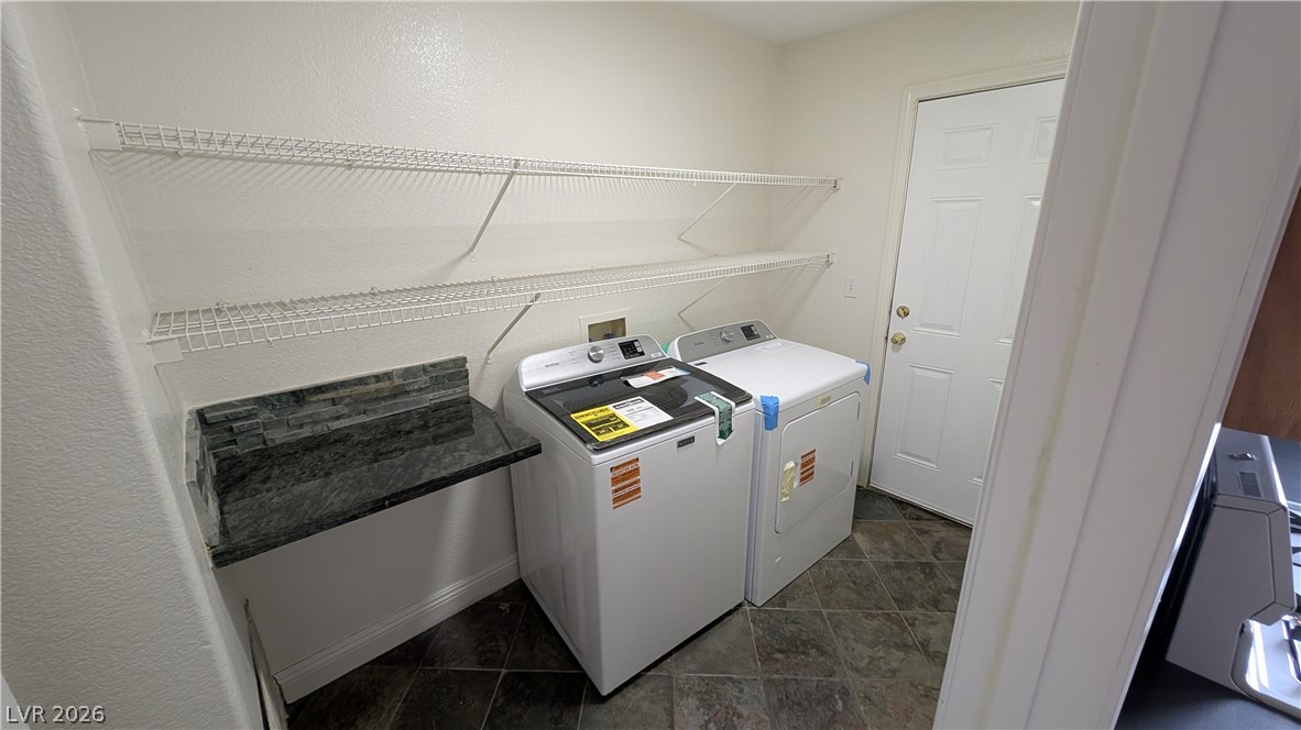 2670 Ridgewater Circle Henderson, NV 89074 - Photo 20 of 22 This functional laundry room features convenient shelving and durable tile flooring.