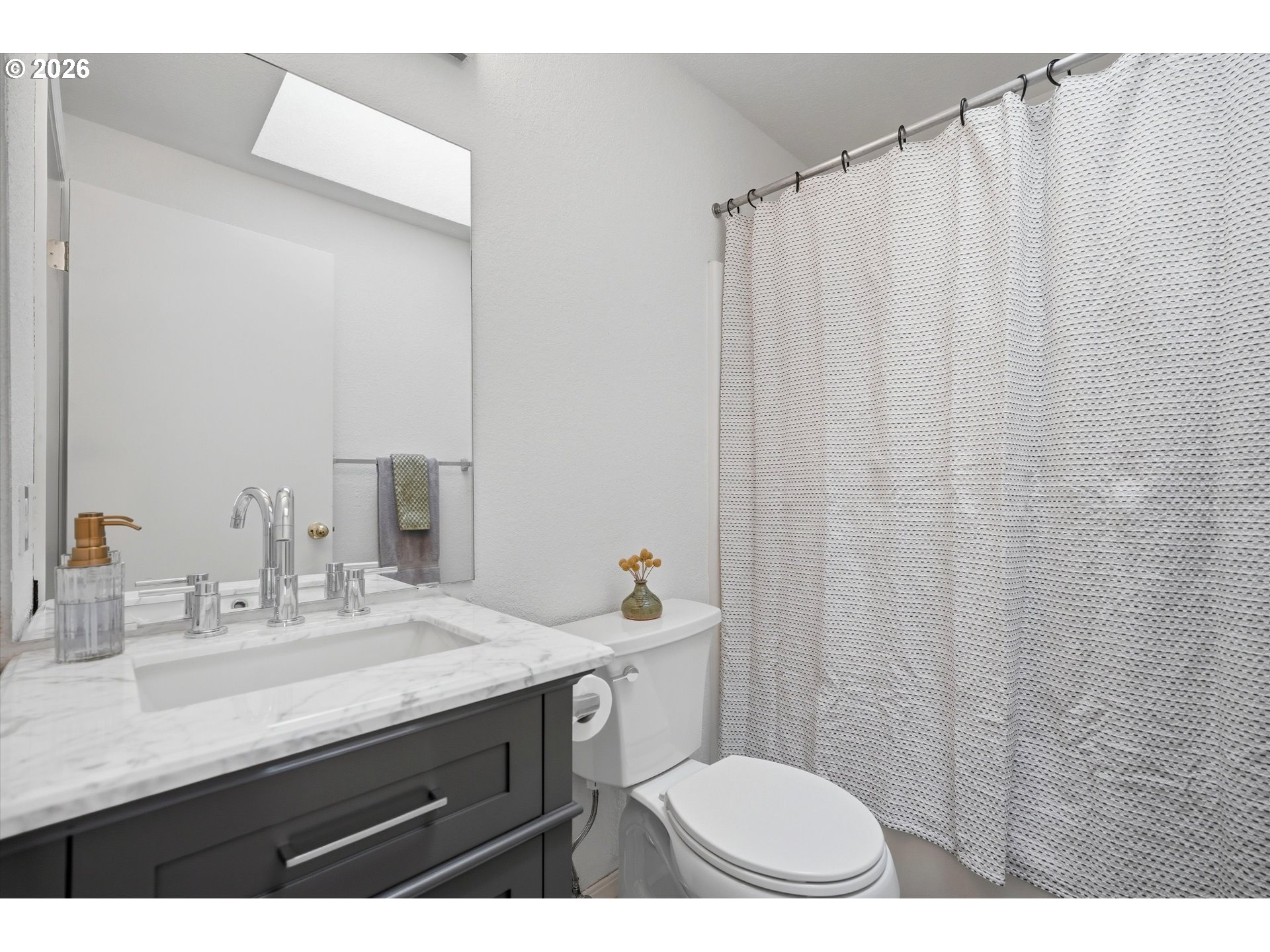 1255 Southwest 217th Avenue Beaverton, OR 97003 - Photo 19 of 33 a bathroom with a sink a toilet and shower curtain