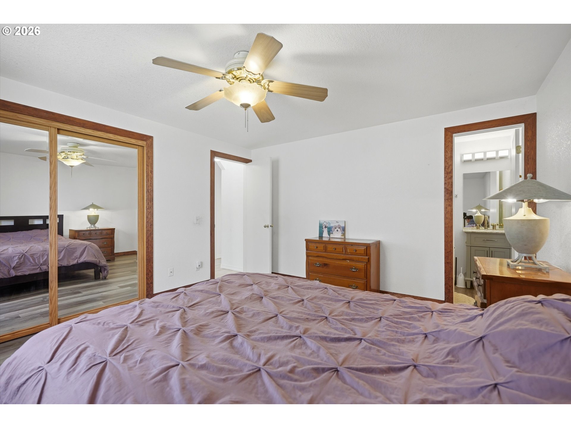1255 Southwest 217th Avenue Beaverton, OR 97003 - Photo 23 of 33 a bedroom with a large bed and a chandelier
