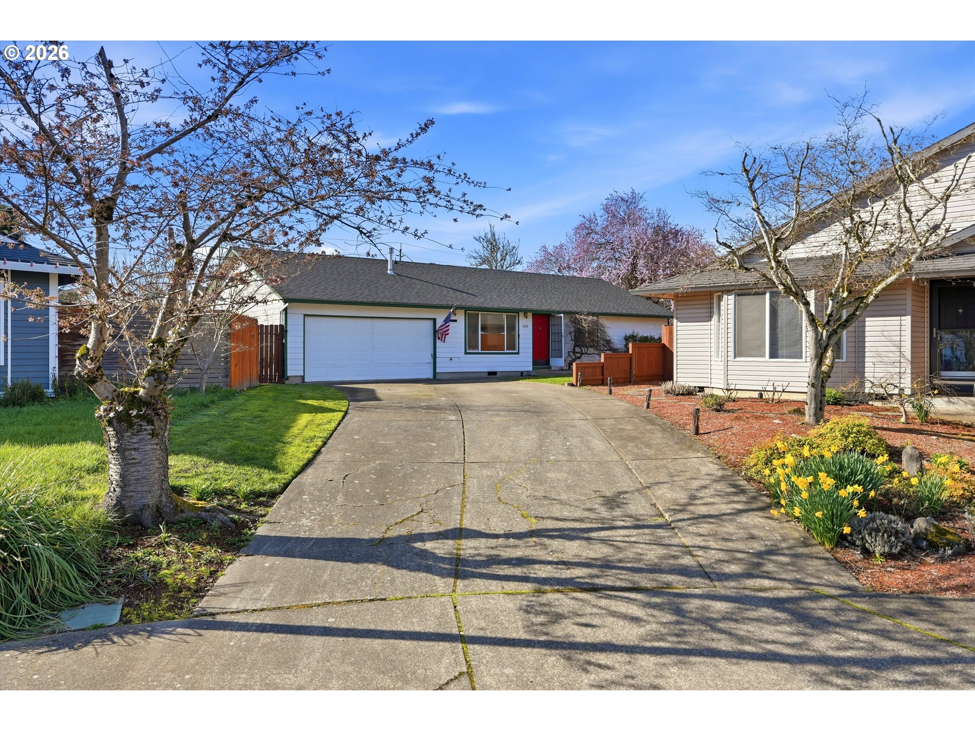 1255 Southwest 217th Avenue Beaverton, OR 97003 - Photo 32 of 33 a view of a white house with a yard